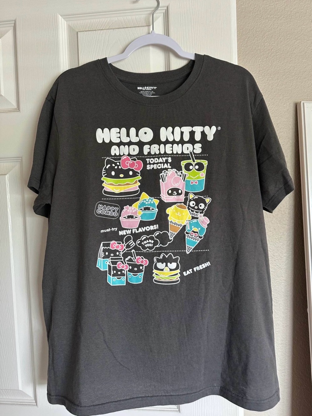 Hello Kitty Black Graphic Tee with Pastel Pink Blue Yellow Green Accents